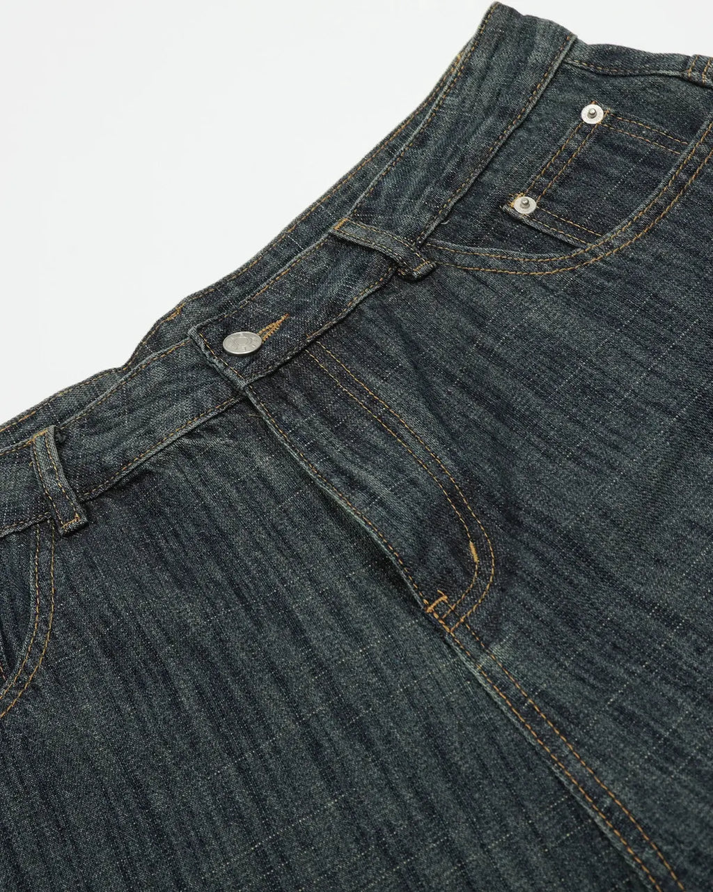 Raw wide-leg long jorts by INFLATION, denim pants with distressed details and a relaxed fit, shown in a natural stance.