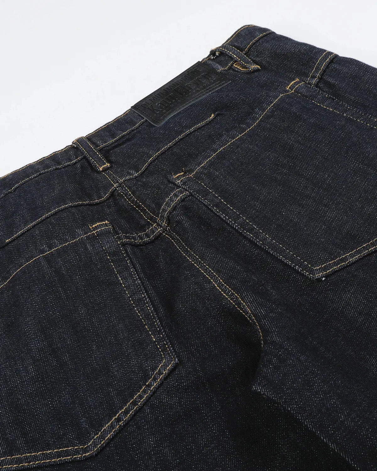 Raw wide-leg jeans with button details from Inflation Streetwear, featuring a relaxed fit and classic denim texture.