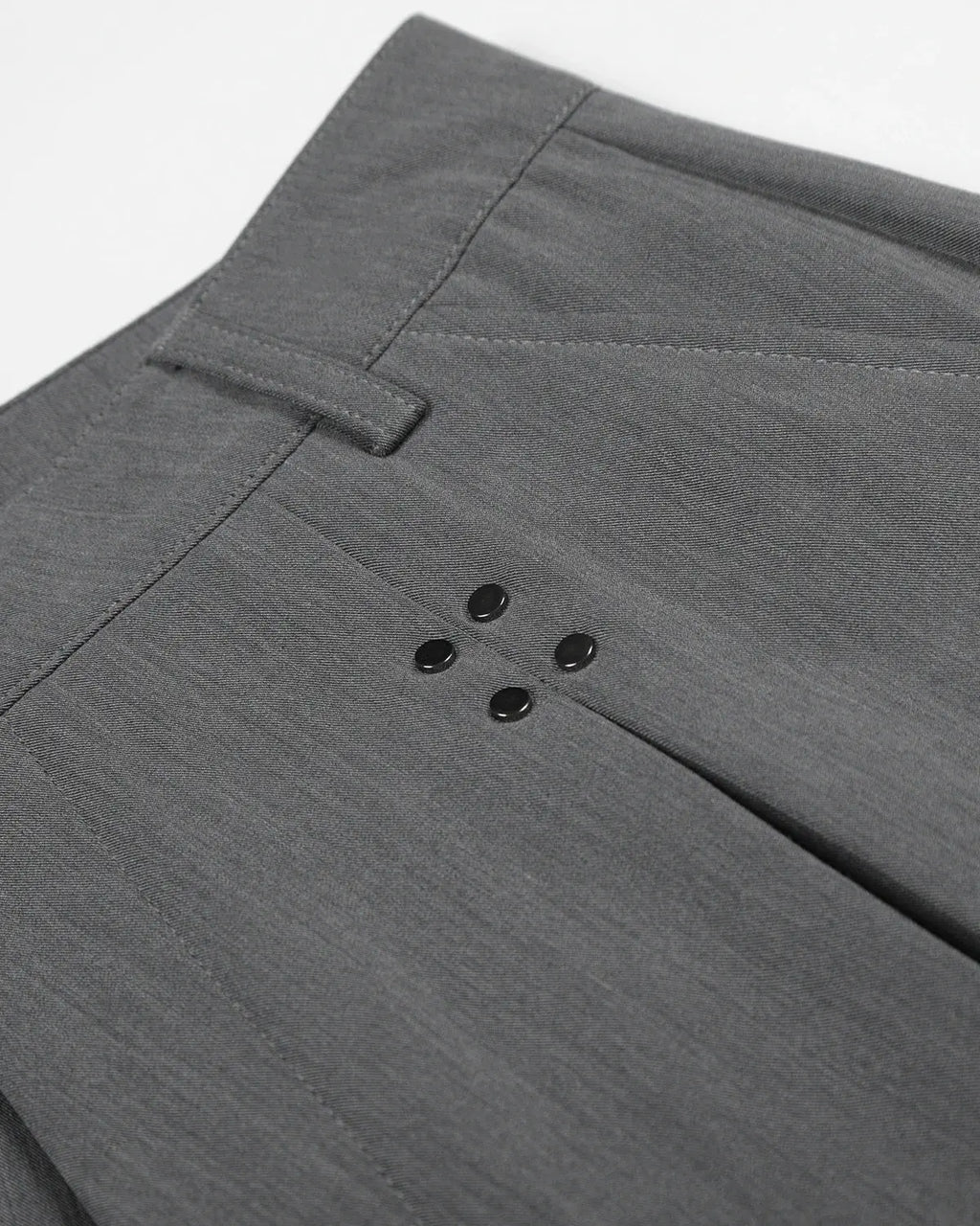 Inflation streetwear pleated tailored shorts with stud details, featuring a stylish fit and structured design in a modern fashion style.