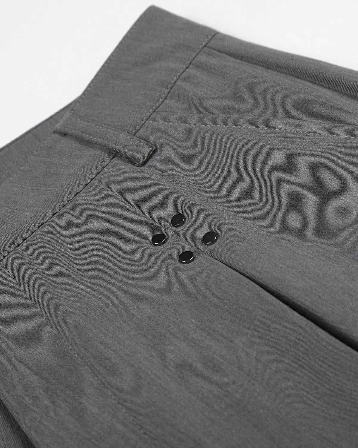 Inflation streetwear pleated tailored shorts with stud details, featuring a stylish fit and structured design in a modern fashion style.
