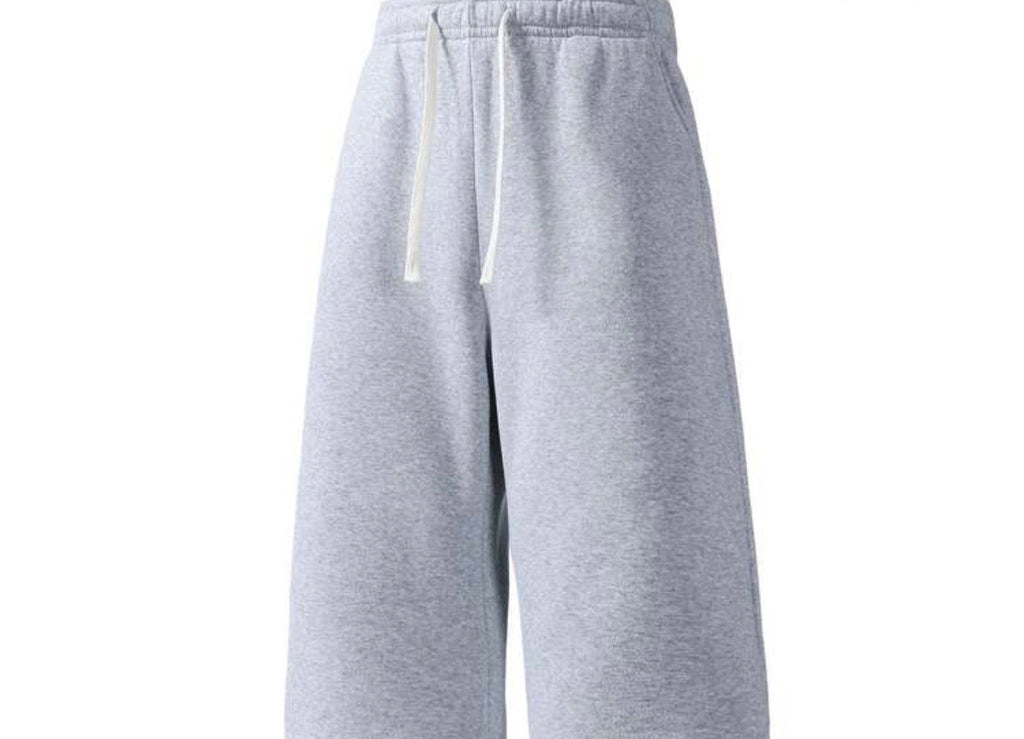 Inflation trending long jogger shorts in black, featuring a relaxed fit with elastic waistband and side pockets.