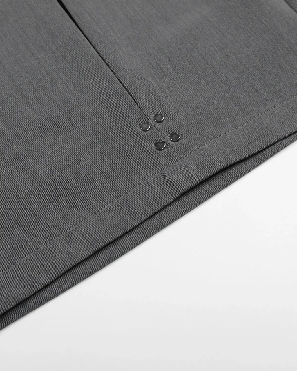 Inflation brand pleated stud detail tailored shorts, stylish pants with a structured fit and metal stud accents, black fabric.