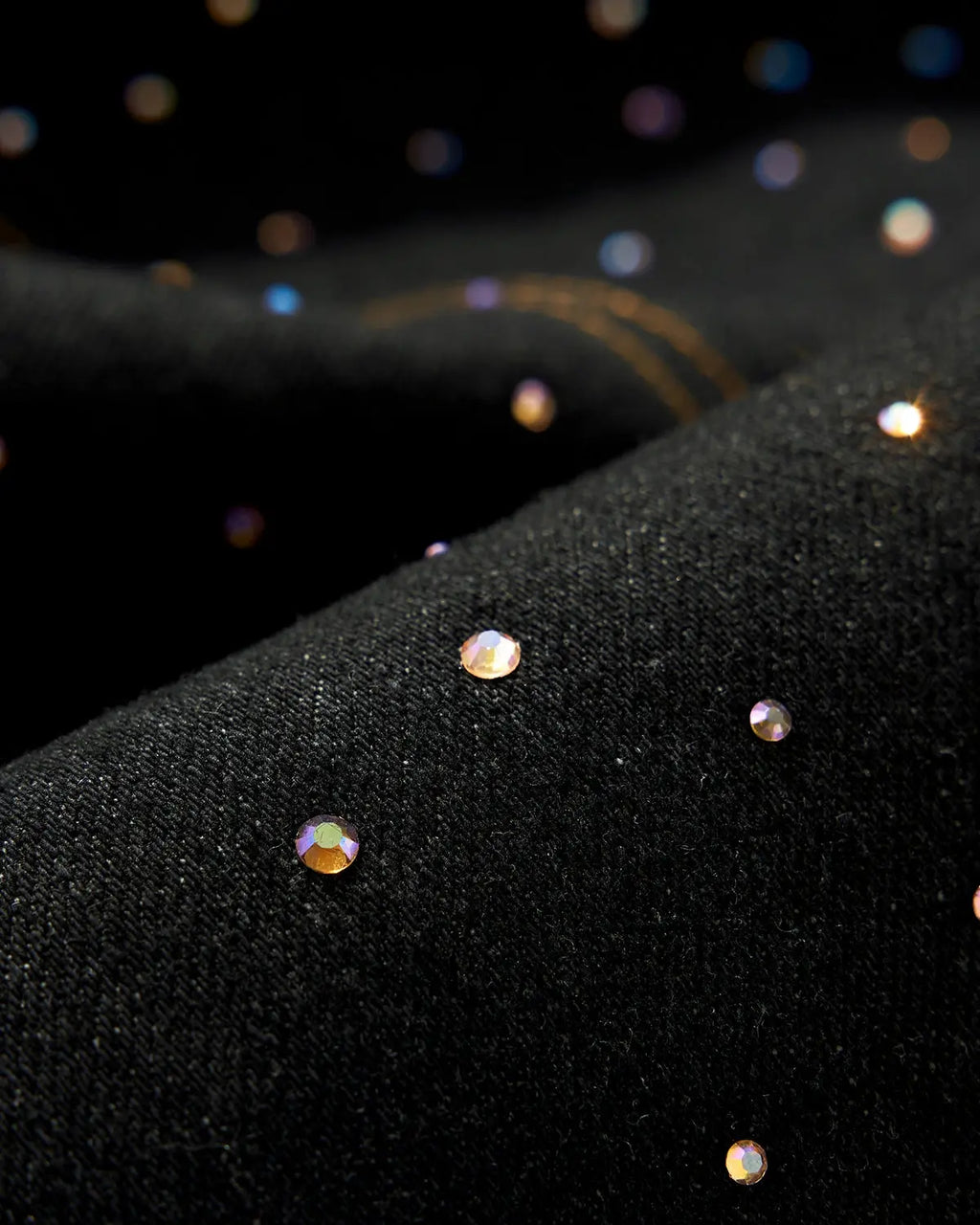 Colorful rhinestone raw barrel jeans by INFLATION featuring vibrant embellishments and distressed denim style.