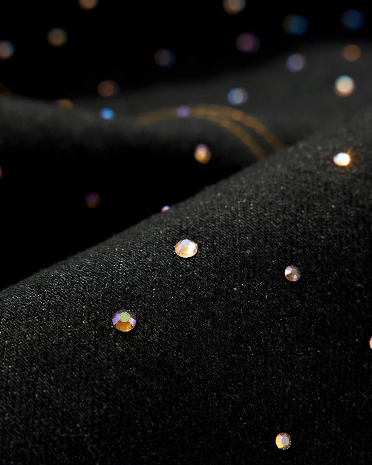 Colorful rhinestone raw barrel jeans by INFLATION featuring vibrant embellishments and distressed denim style.