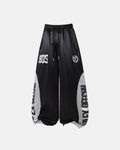 Glossy contrast barrel sweatpants by INFLATION featuring a shiny finish and relaxed fit, shown laid flat with waist and leg details.