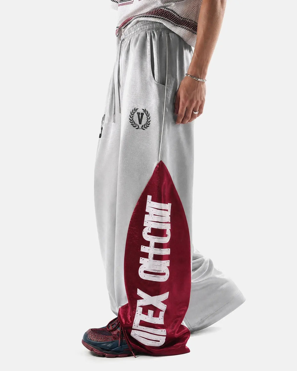Glossy black and white contrast barrel sweatpant by INFLATION, featuring a relaxed fit and bold streetwear style.