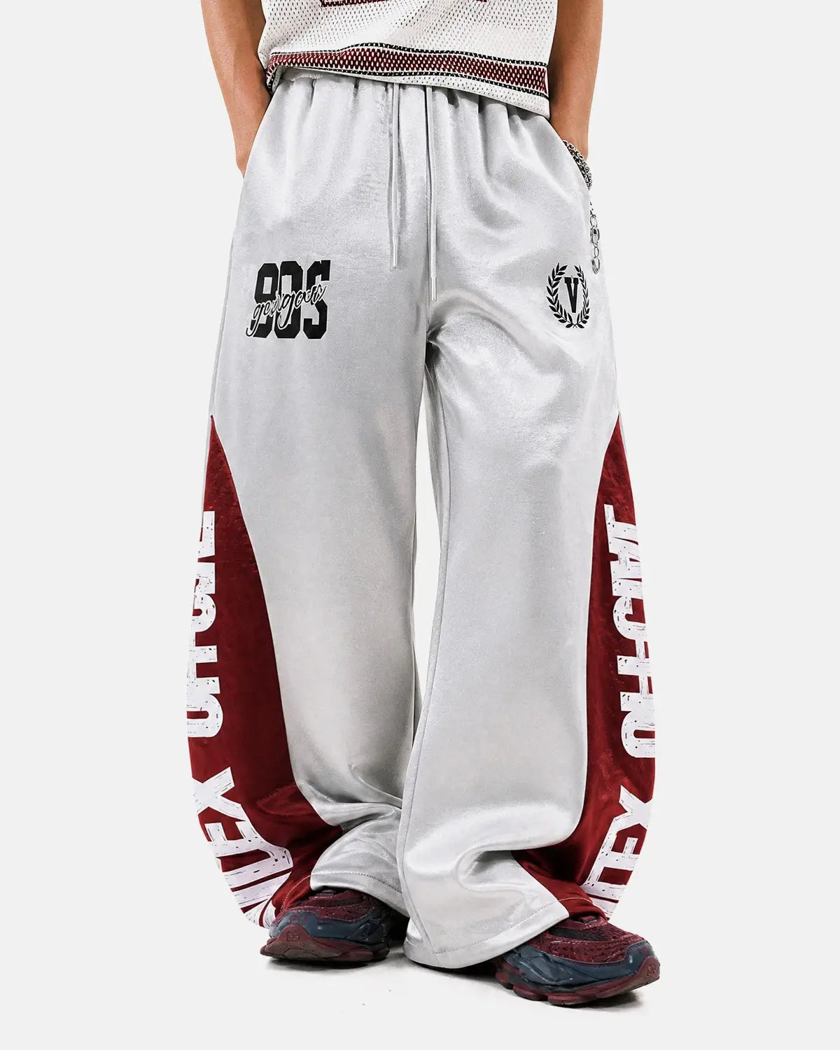 Glossy contrast barrel sweatpant by INFLATION, featuring a stylish design with shiny fabric and relaxed fit, shown on a model.