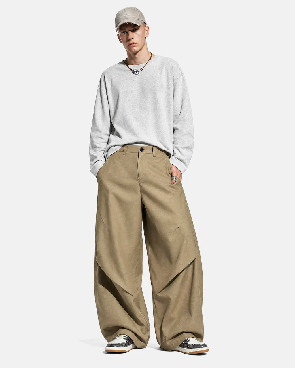 Inflation Streetwear Pleated Barrel Tailored Pants in neutral fabric, featuring a high waist and loose, tapered fit.