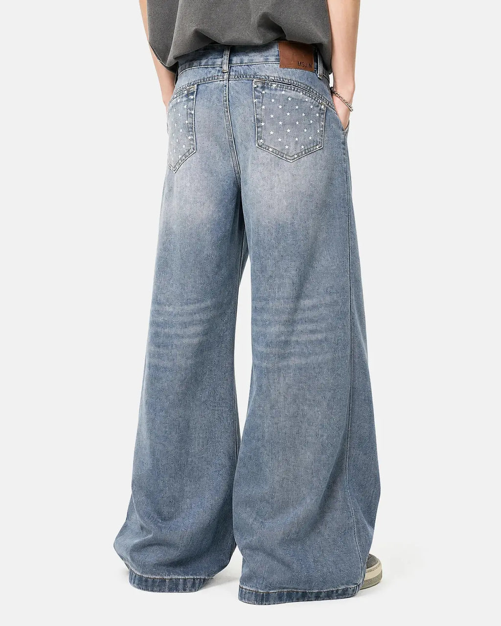 Inflation Star Pocket Bootcut Jeans featuring star-embellished pockets and classic denim fit, worn by a model.