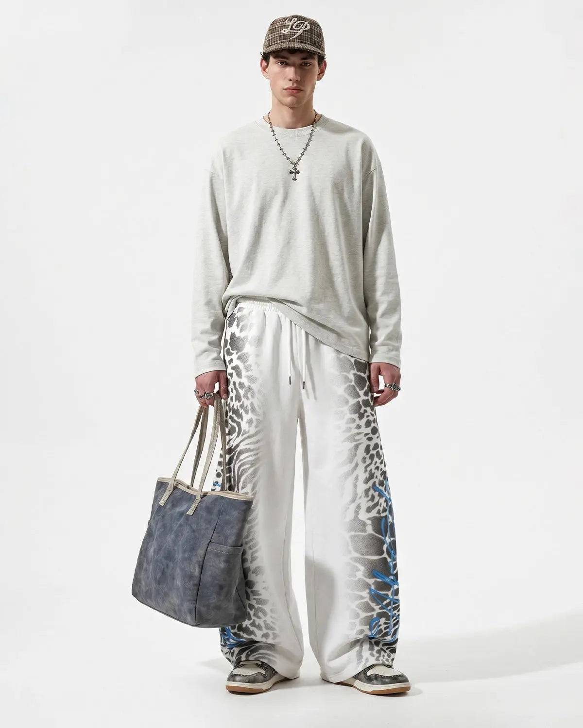 Leopard graphic design on black barrel sweatpants by INFLATION, streetwear style with relaxed fit and bold animal print.