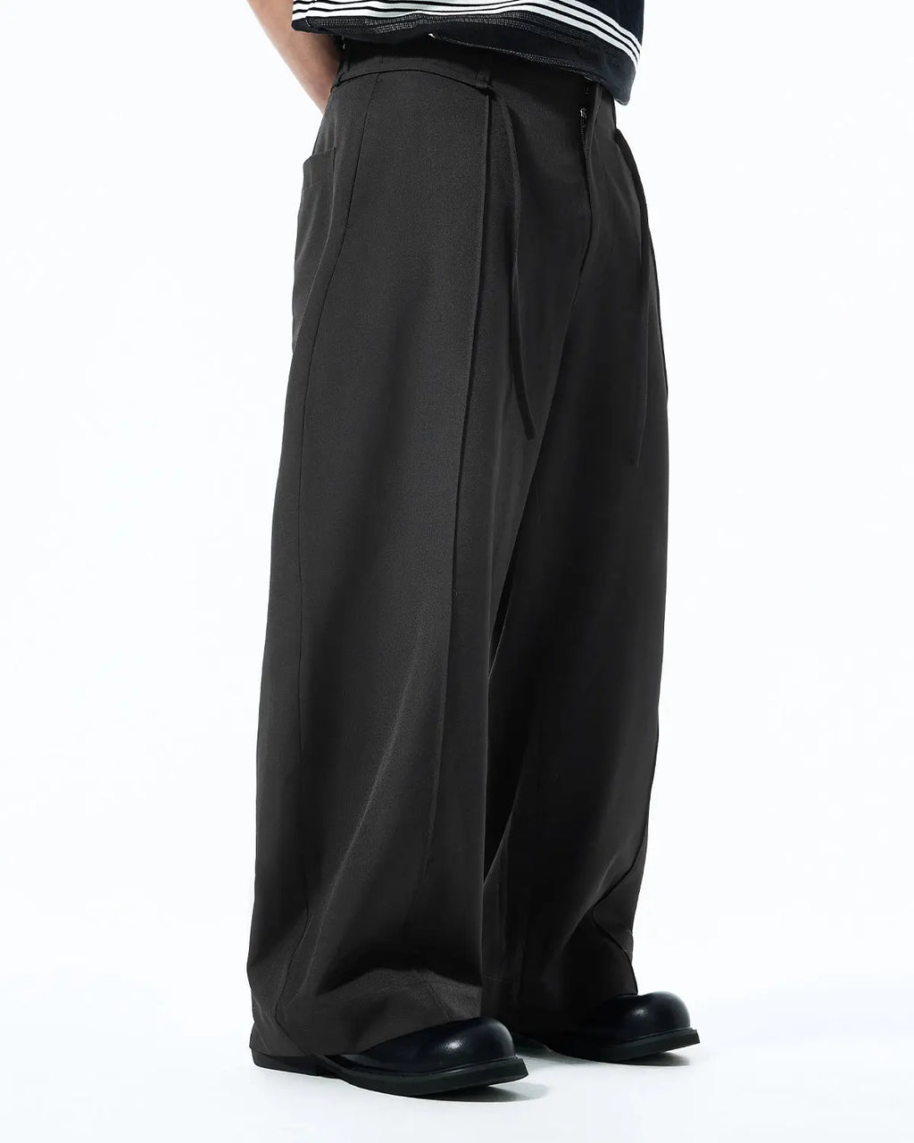 Inflation Cleanfit Baggy Suit Pants in black with a relaxed fit, featuring a high waist and adjustable drawstring waistband.