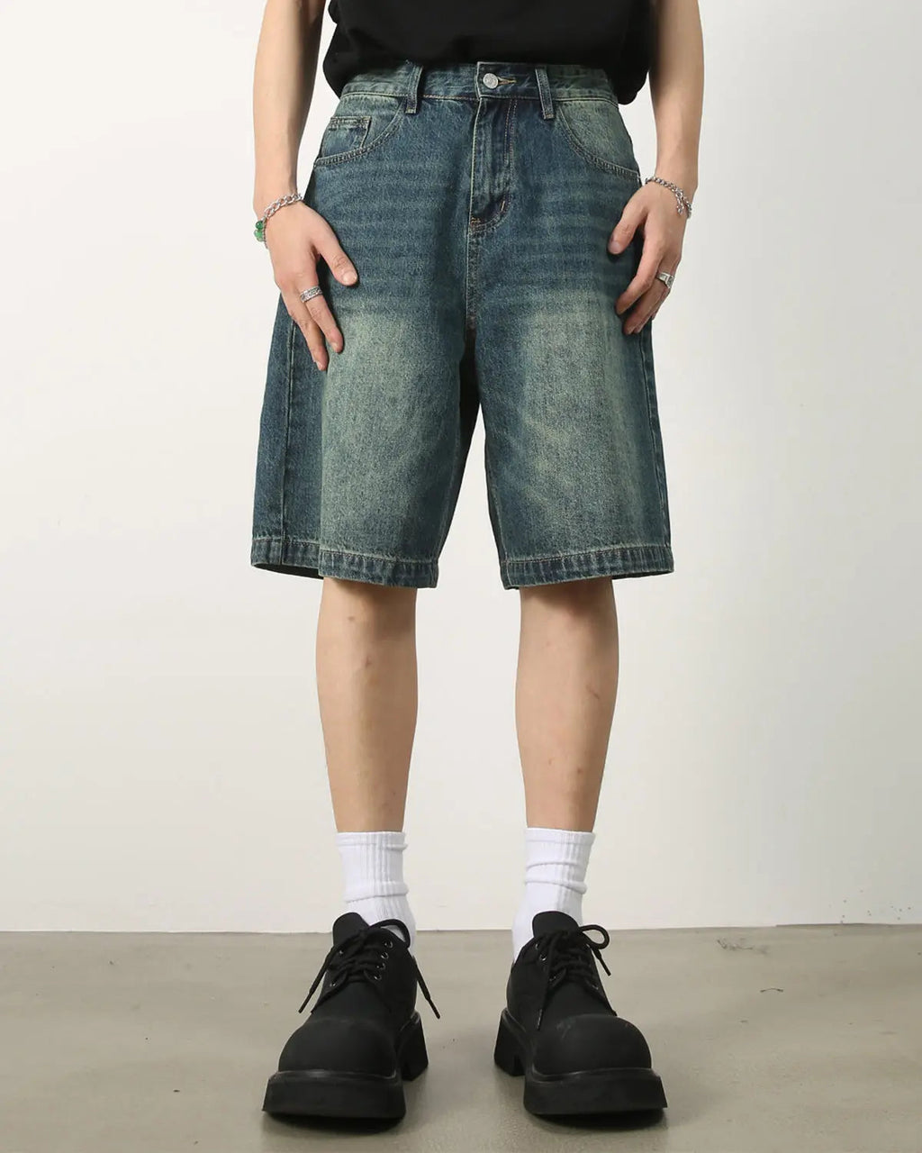 Washed knee-length denim jorts by INFLATION, casual streetwear pants with a relaxed fit and faded blue denim fabric.