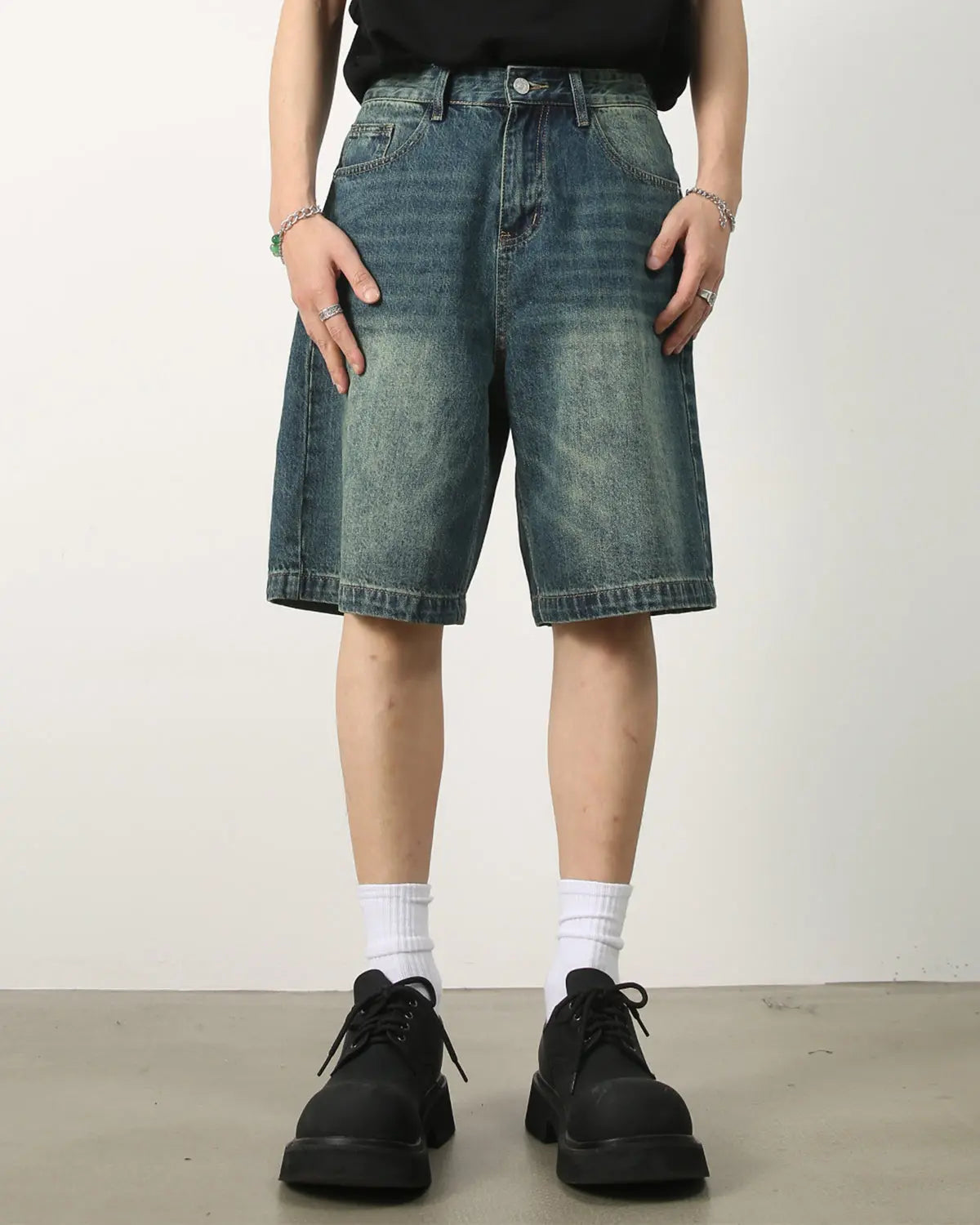 Washed knee-length denim jorts by INFLATION, casual streetwear pants with a relaxed fit and faded blue denim fabric.