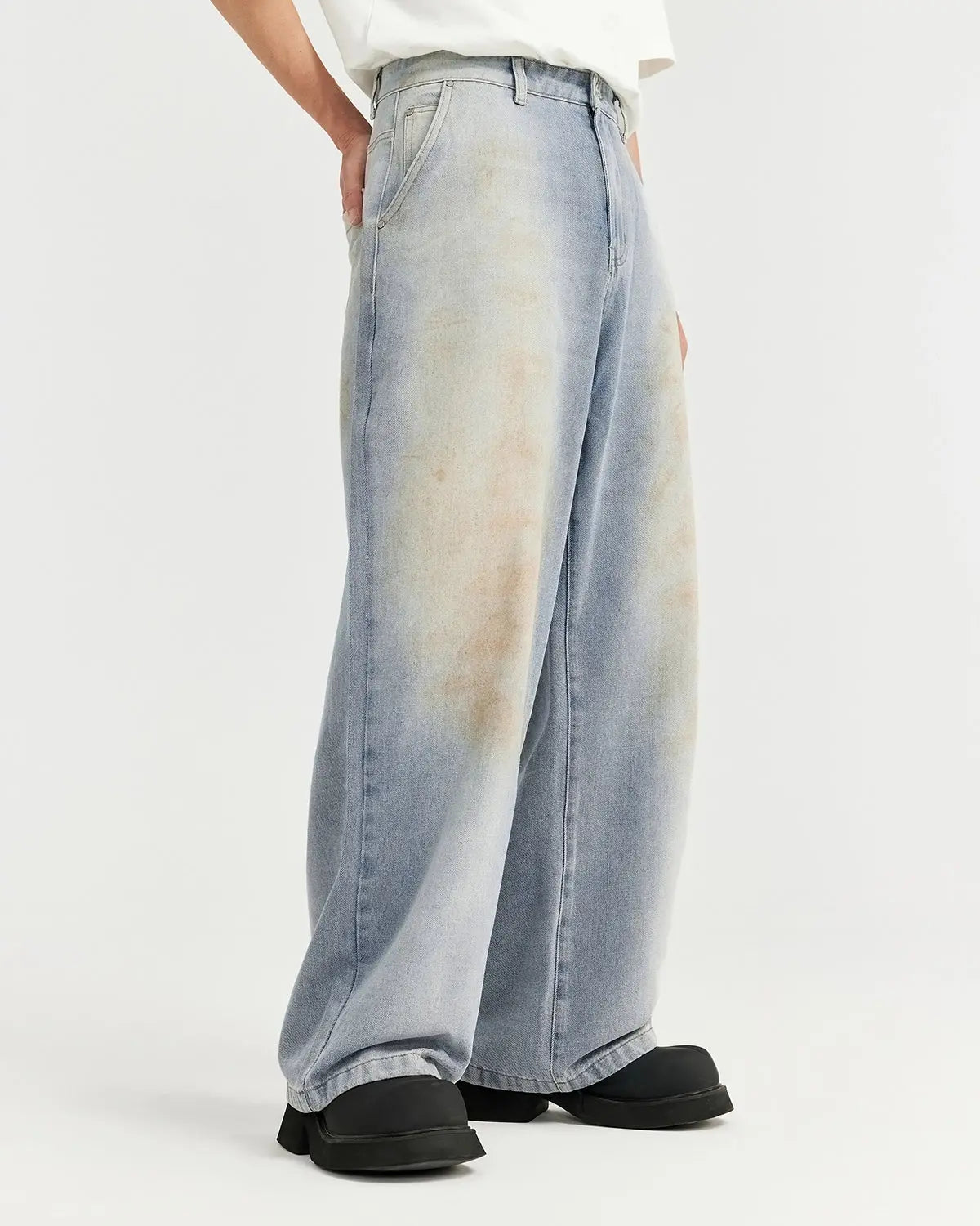 Mud washed baggy jeans by INFLATION Streetwear featuring a relaxed fit, faded denim, and distressed details.