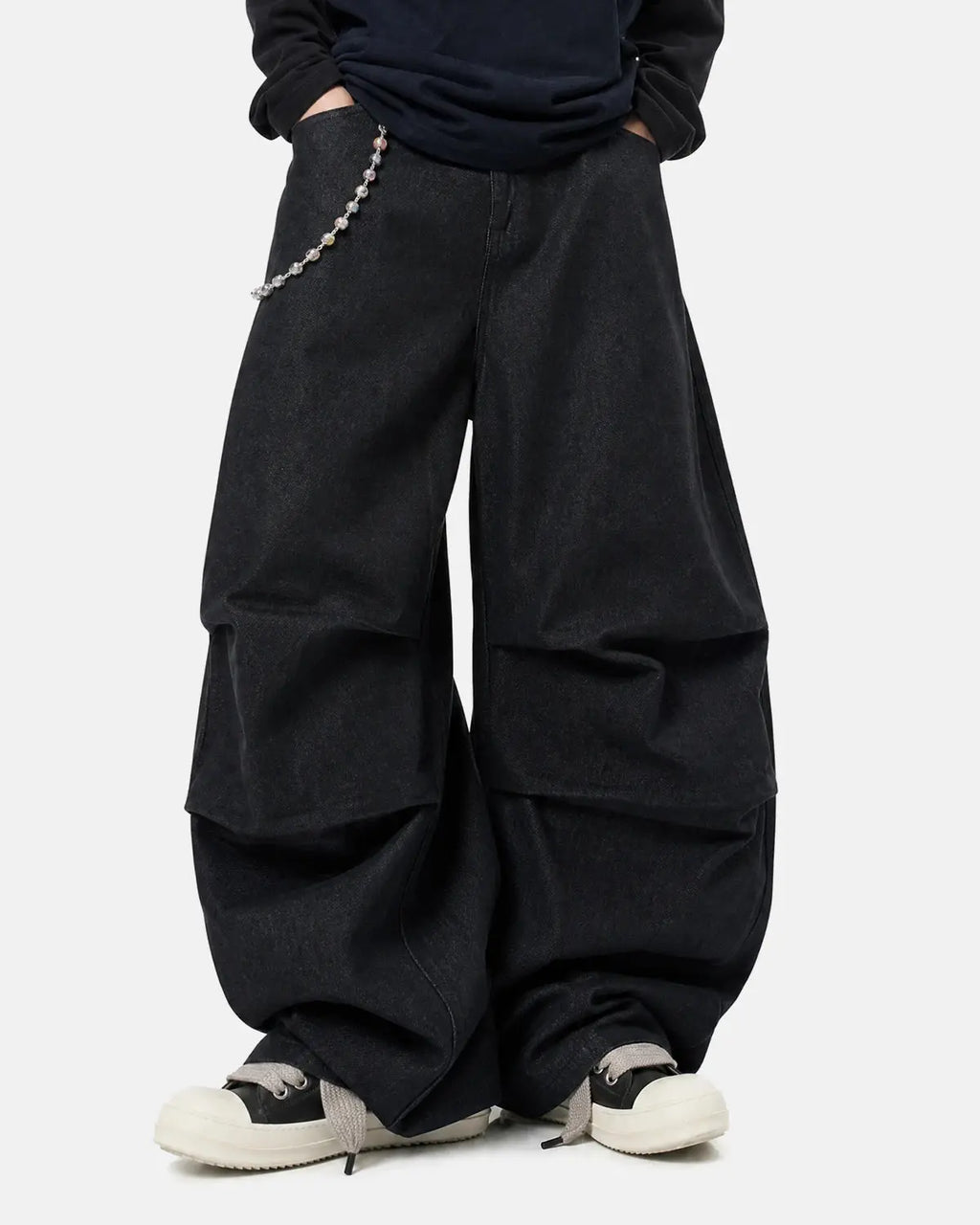 Inflation Super Raw Baggy Jeans featuring a loose fit, distressed denim, and streetwear style, worn by a model.