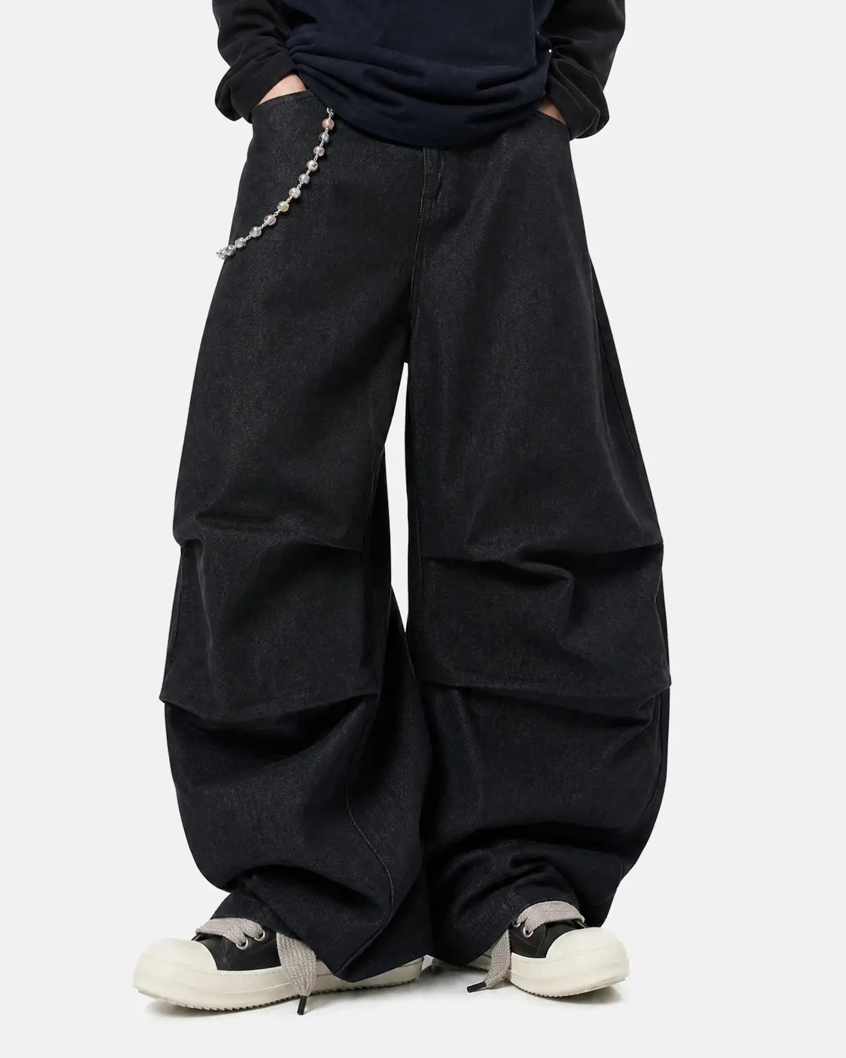 Inflation Super Raw Baggy Jeans featuring a loose fit, distressed denim, and streetwear style, worn by a model.
