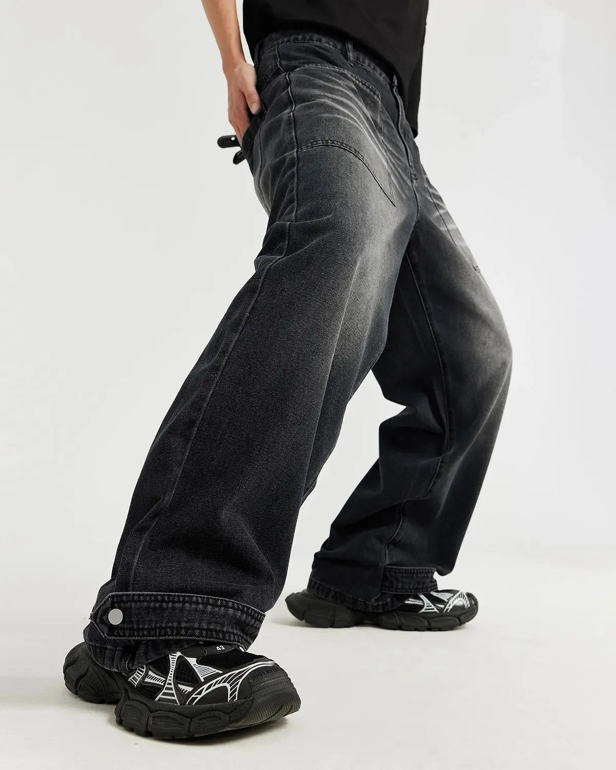 Black washed baggy jeans by INFLATION Streetwear featuring a relaxed fit and distressed denim texture.