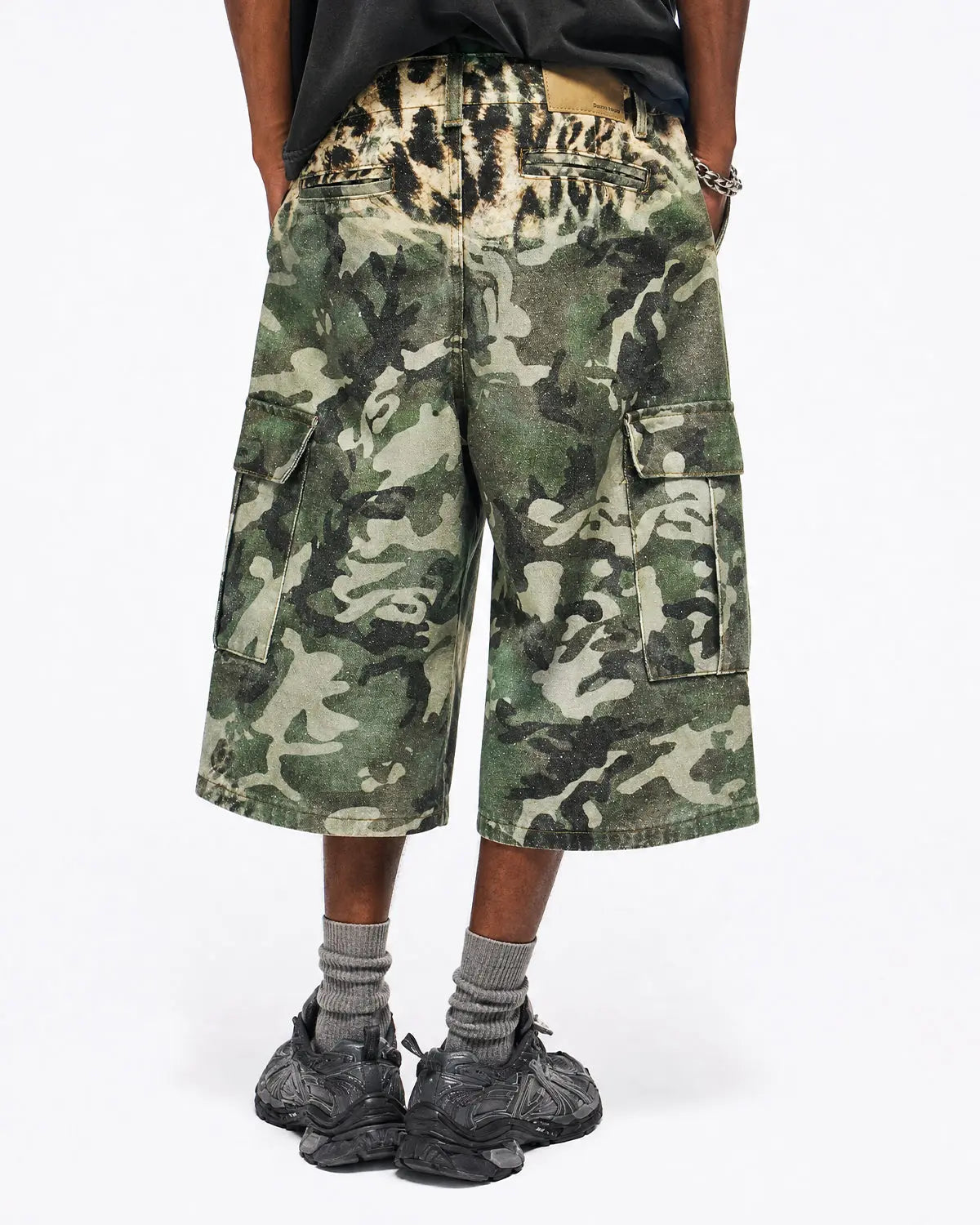 Leopard camo cargo longline shorts by INFLATION featuring a relaxed fit, multiple pockets, and bold streetwear style.
