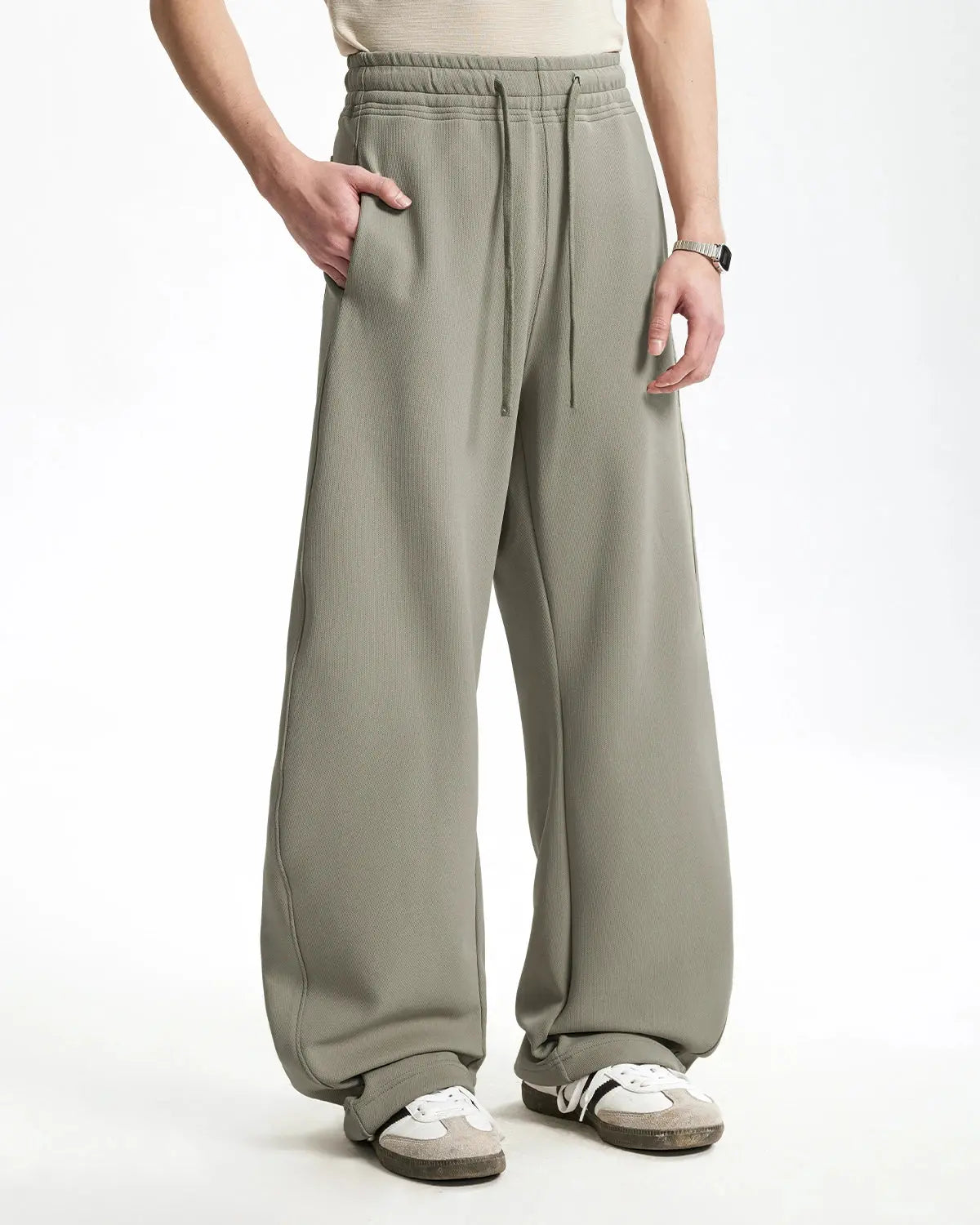 Inflation grey baggy sweatpants with relaxed fit and elastic waistband, casual loungewear style, shown on a model.
