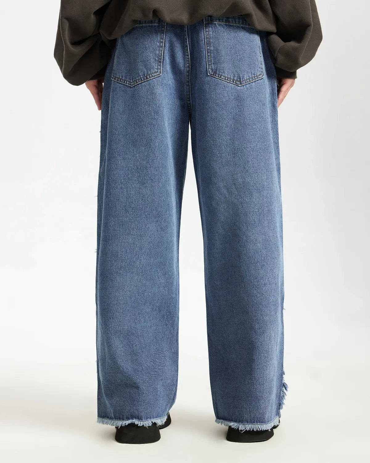 Blue frayed acid wash pants from Inflation Streetwear, casual fit with distressed details and frayed hems, stylish streetwear look.
