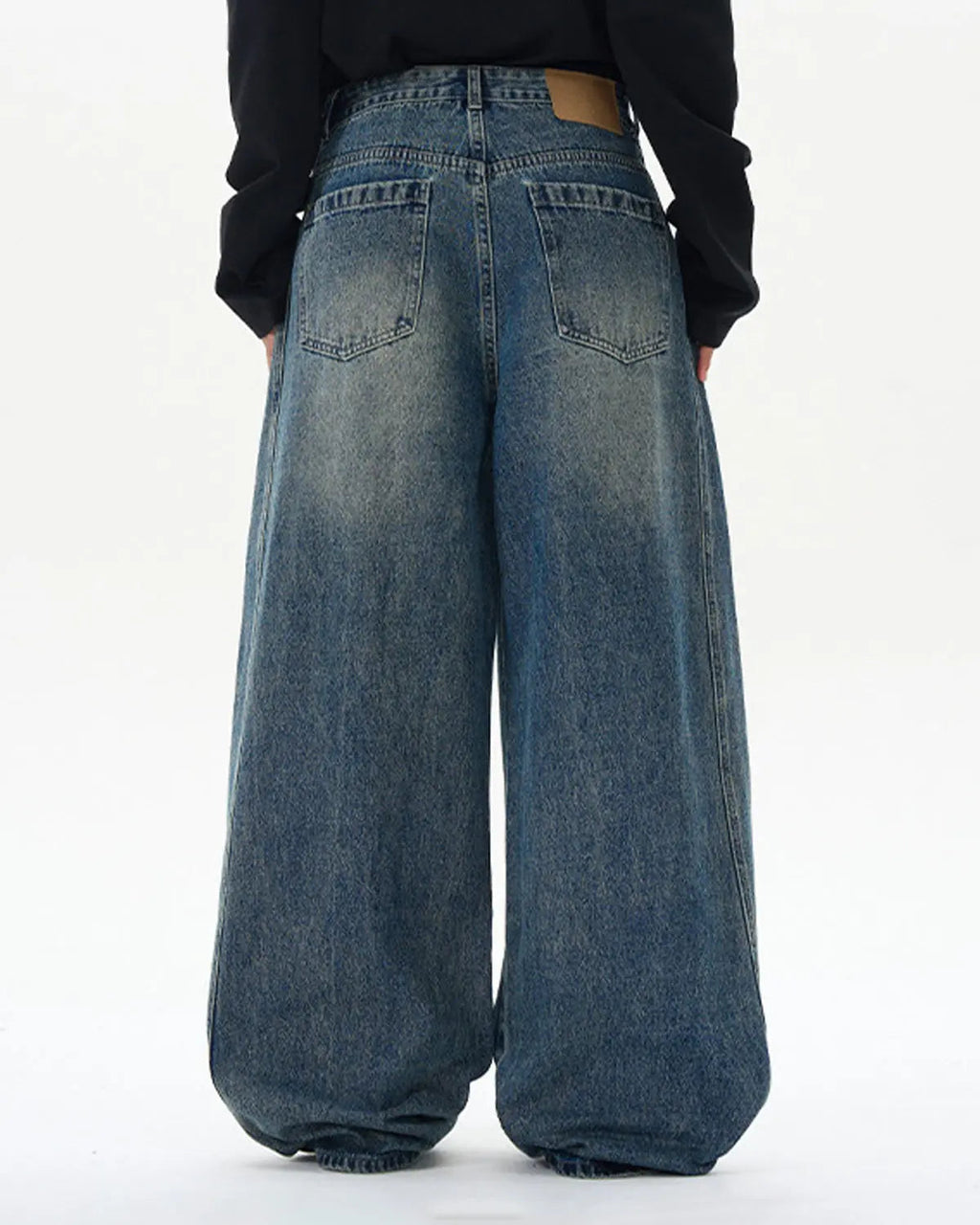 Deconstructed washed barrel jeans by INFLATION Streetwear featuring distressed denim and unique layered design.