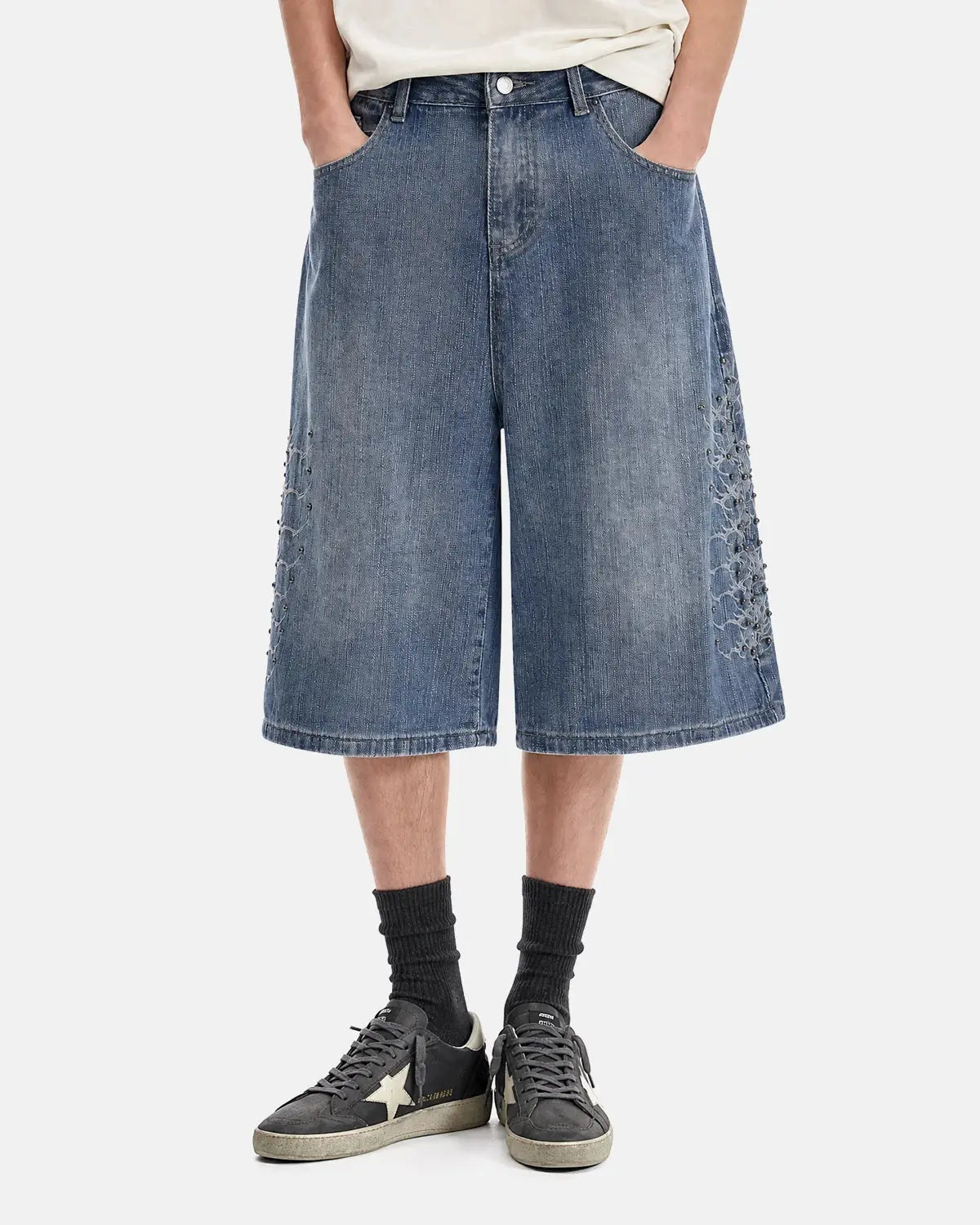 Inflation Streetwear studded bamboo weave jorts, casual denim-style pants with metal studs, styled for streetwear fashion.