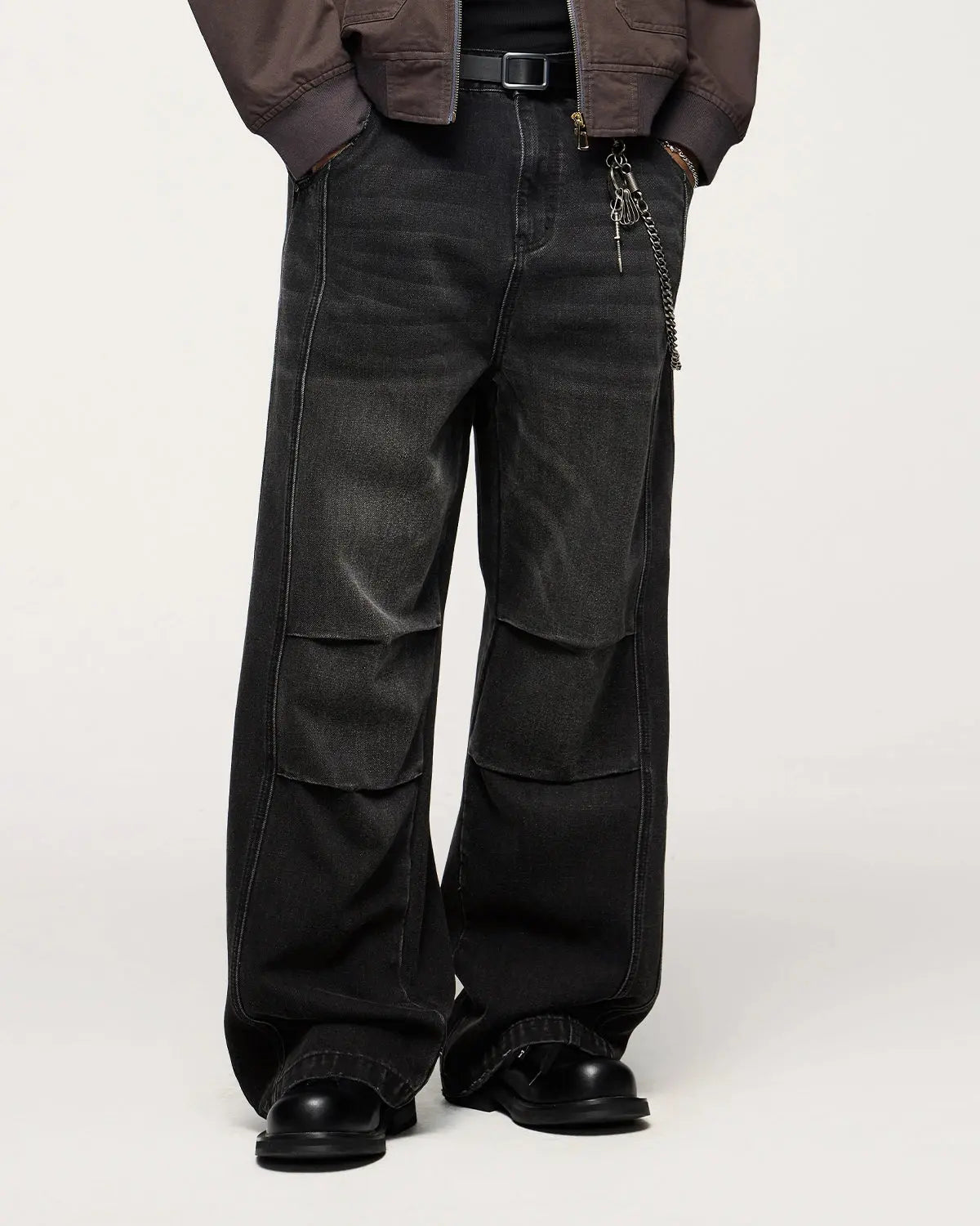 Inflation faded dirty baggy cargo jeans with distressed details and relaxed fit, shown on a model.