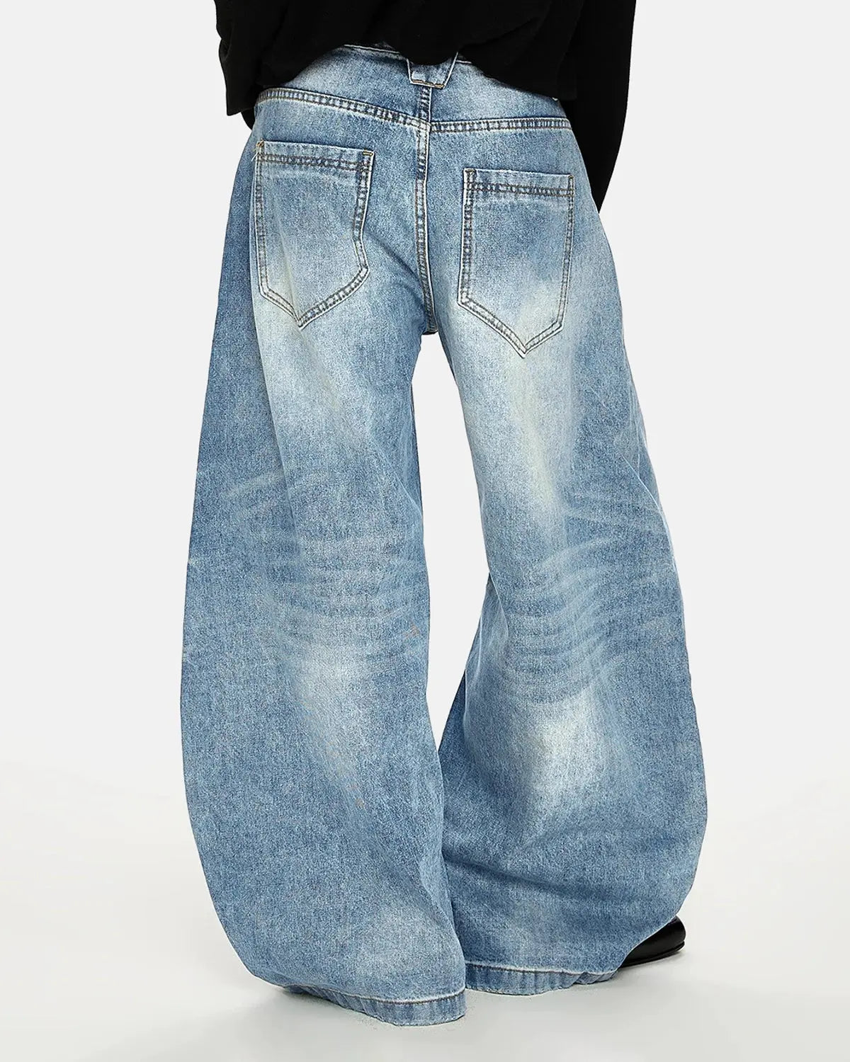 Acid washed Whisker Clasp Barrel Jeans by INFLATION featuring distressed denim, relaxed fit, and unique barrel design.