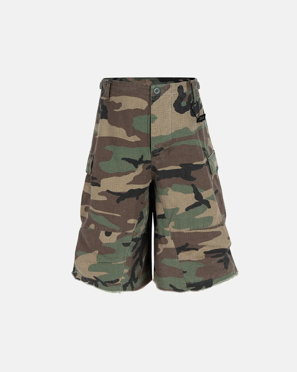 Inflation Streetwear oversized camo cargo longline shorts with multiple pockets and relaxed fit, featuring green and brown camouflage pattern.