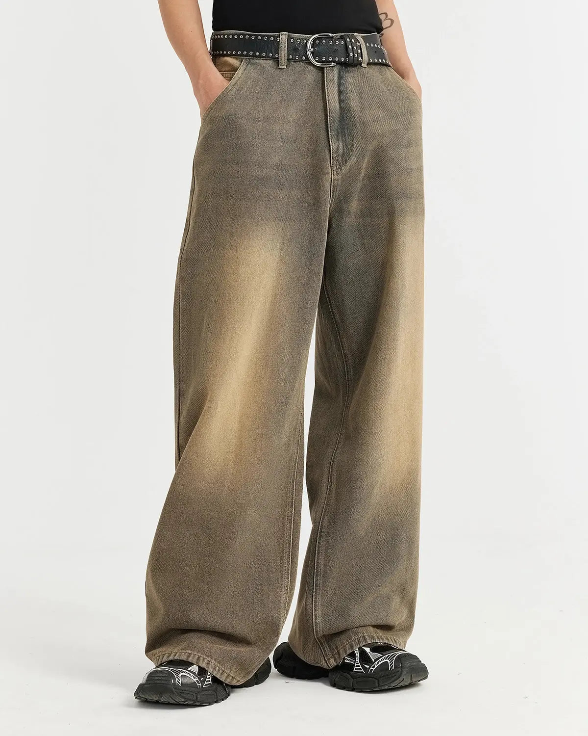 Brown acid wash baggy jeans by INFLATION, featuring a relaxed fit and distressed style, shown on a model.
