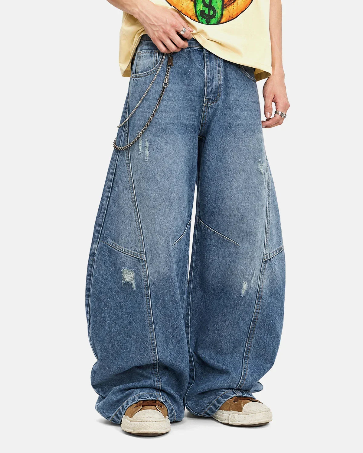 Acid washed distressed barrel jeans by INFLATION featuring a relaxed fit and worn-in style, with frayed edges and faded denim.