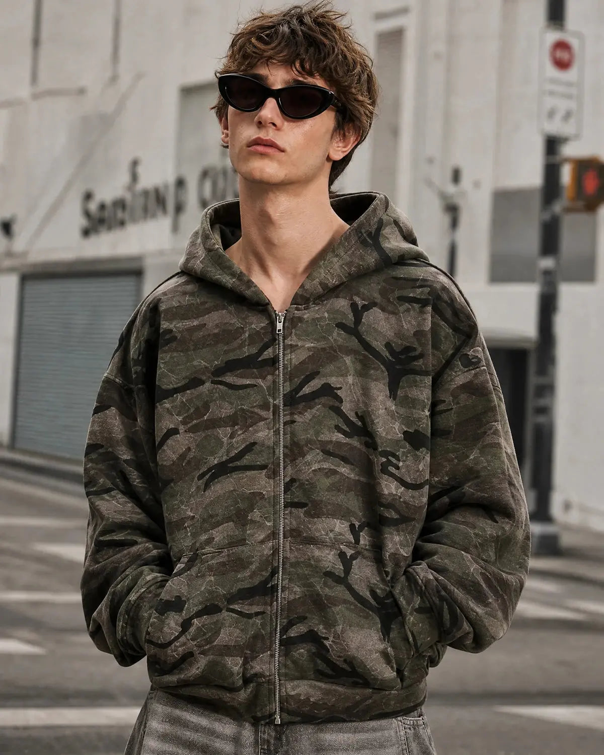 Camouflage zip-up jacket from Inflation Streetwear featuring a camouflage pattern, hood, and full front zipper.