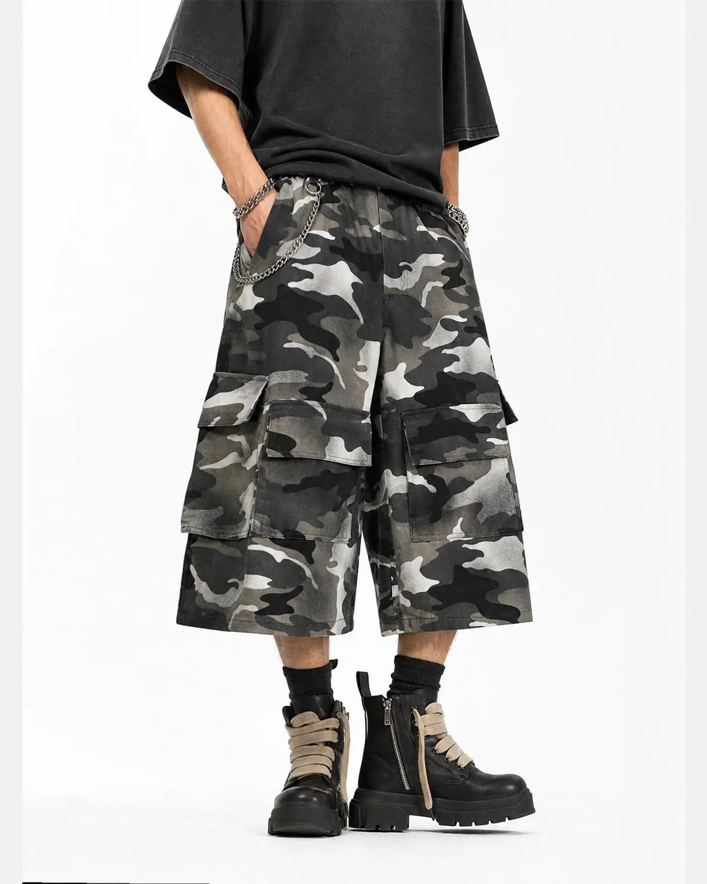 Grey camo utility longline shorts by INFLATION, featuring a relaxed fit with multiple pockets and a high-rise waist.