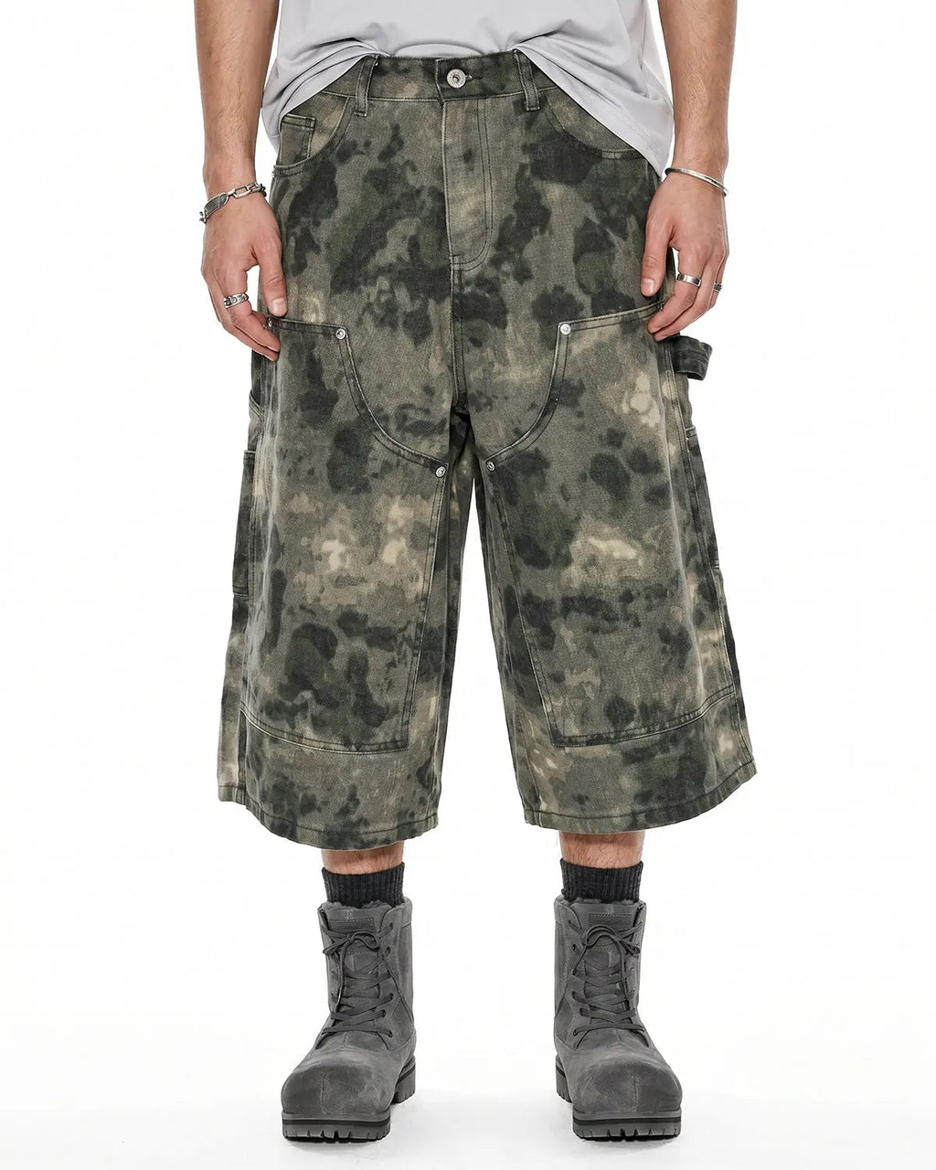 Washed camo cargo longline shorts by INFLATION, featuring multiple pockets and a relaxed fit, styled for streetwear.