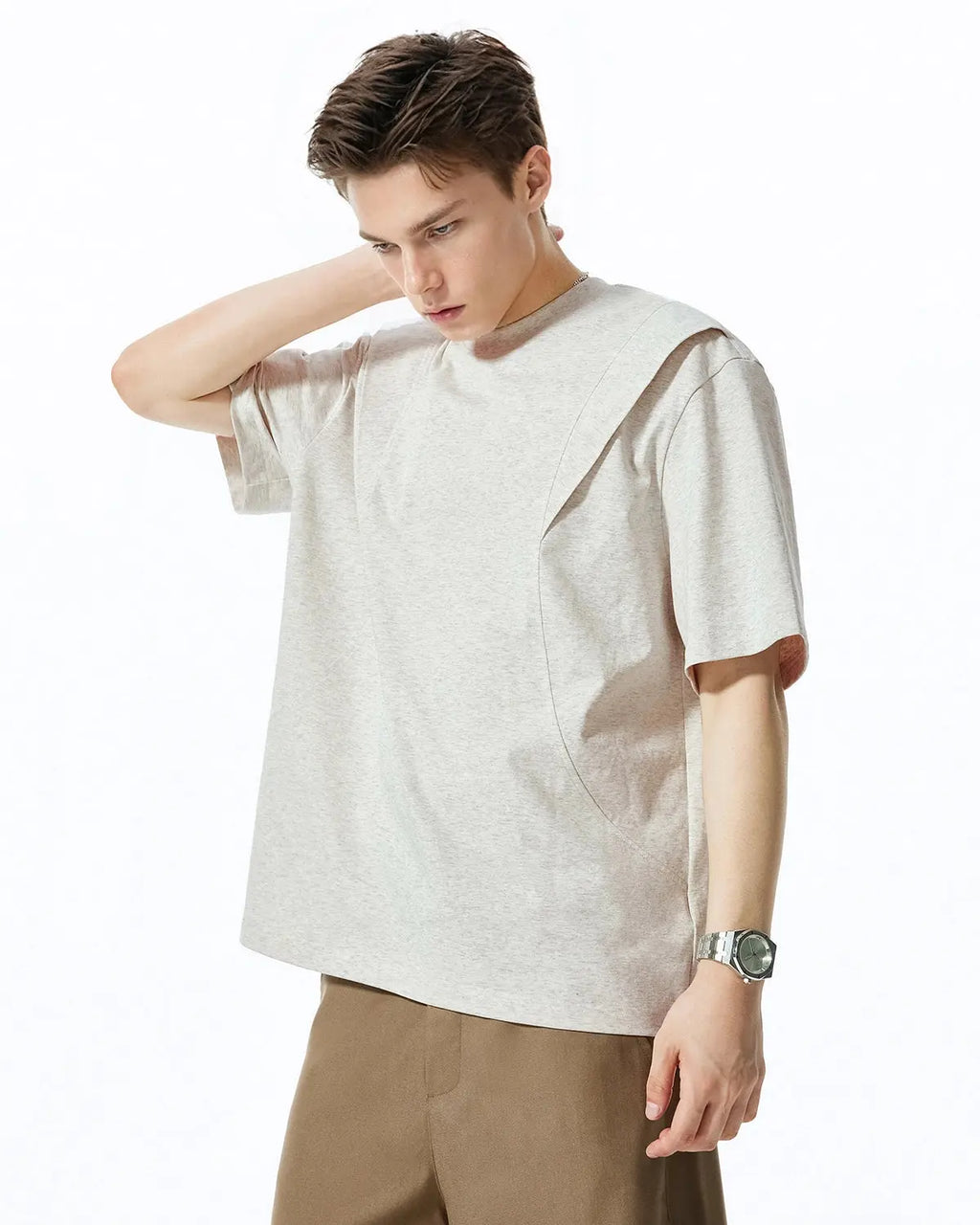 Deconstructed oversized T-shirt by INFLATION, featuring a relaxed fit and raw edges, displayed on a hanger.