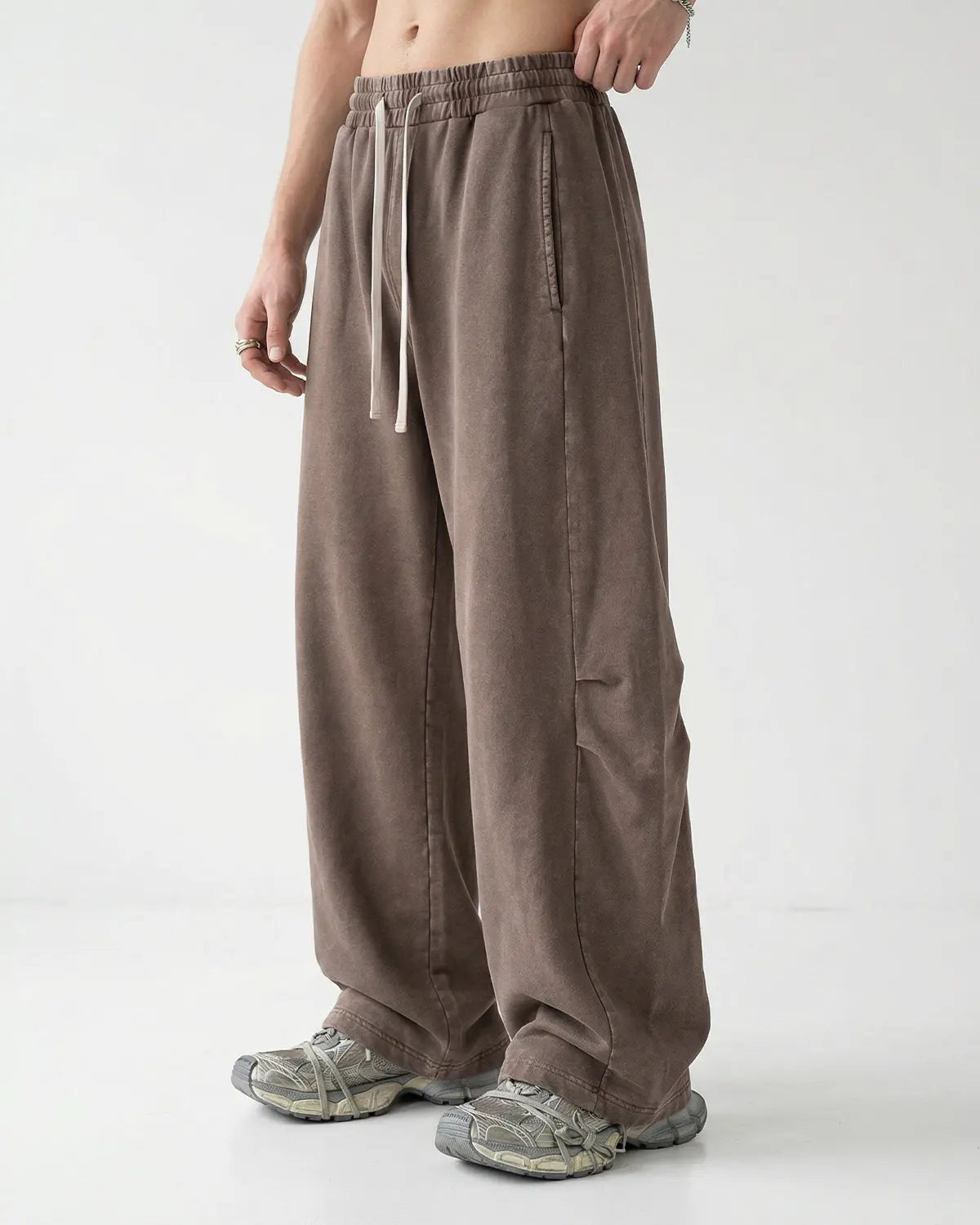 Distressed acid washed barrel sweatpant by INFLATION Streetwear, showing the relaxed fit and unique textured fabric.
