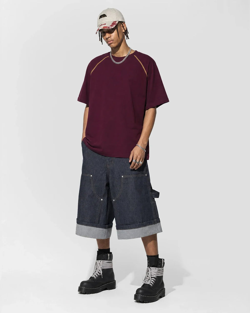 Inflation streetwear T-shirt with contrast color stitching, slim fit design, and casual style, shown in black with colorful stitching details.