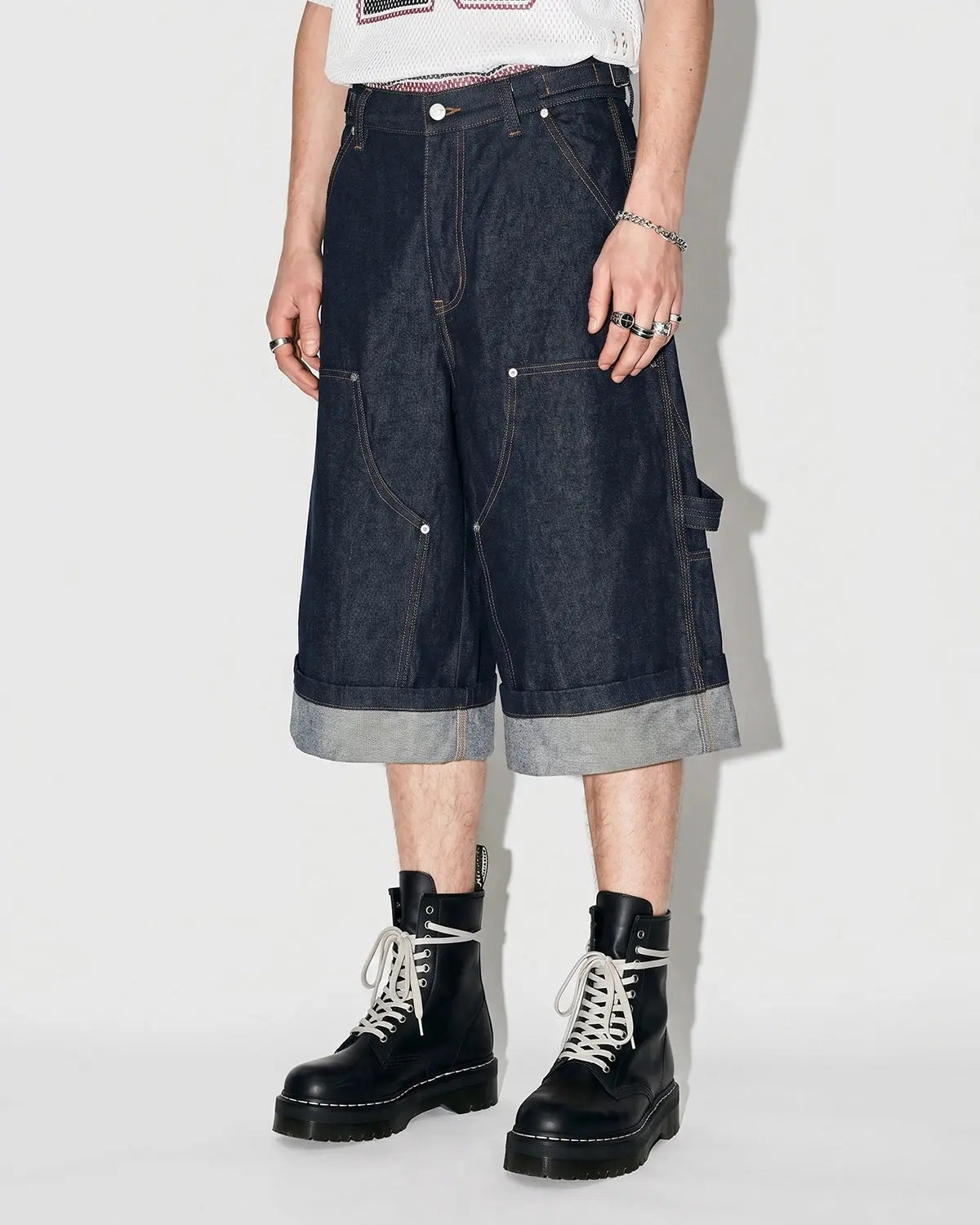 Raw denim carpenter long jorts by INFLATION Streetwear, showing the distressed, rugged design with belt loops and side pockets.