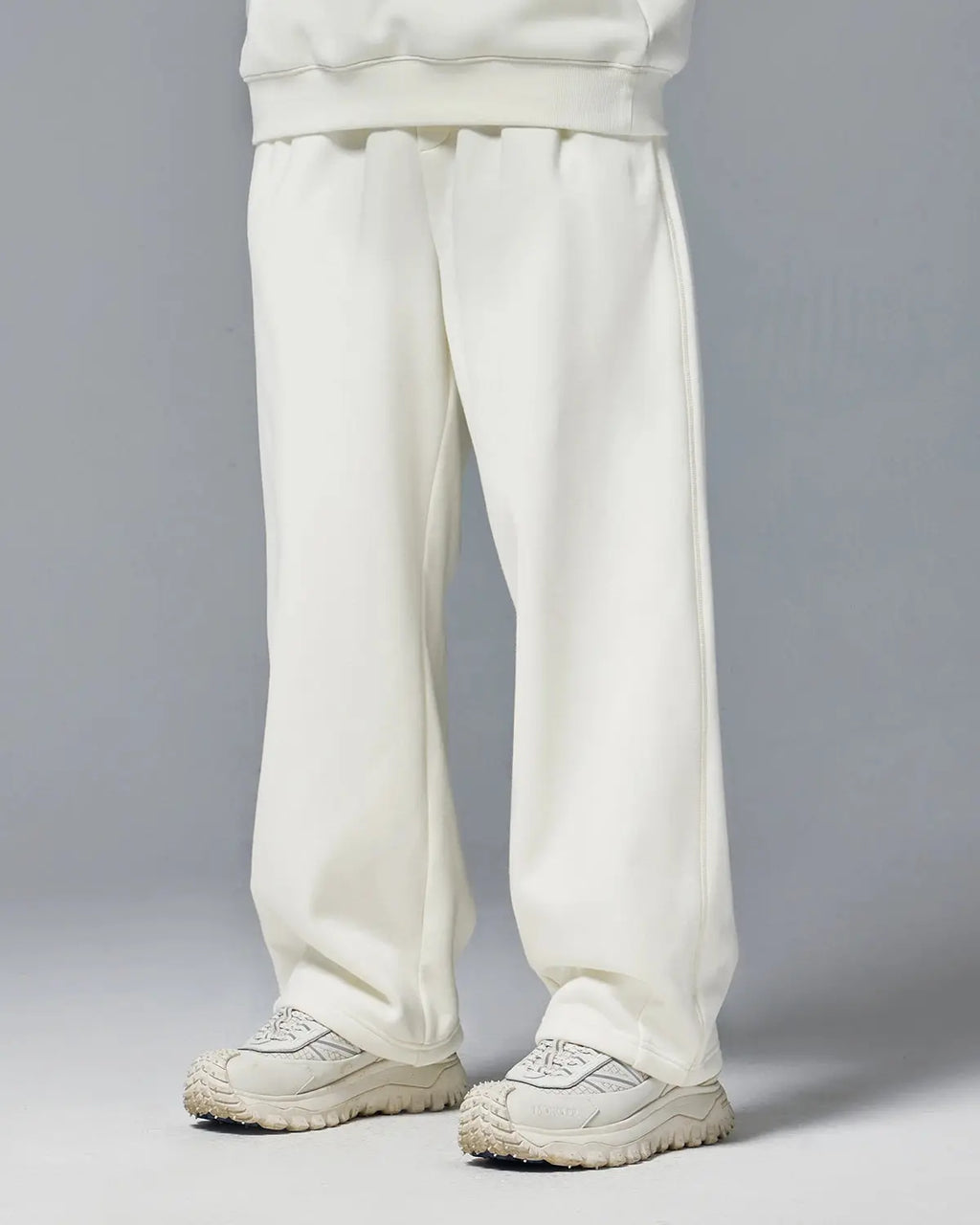 INFLATION stretch thermal fleece sweatpants, cozy and flexible for cold weather, featuring an elastic waistband and tapered fit.