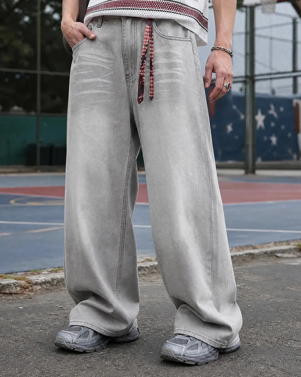 Washed distressed baggy jeans by INFLATION, featuring a relaxed fit, ripped details, and a casual streetwear style.