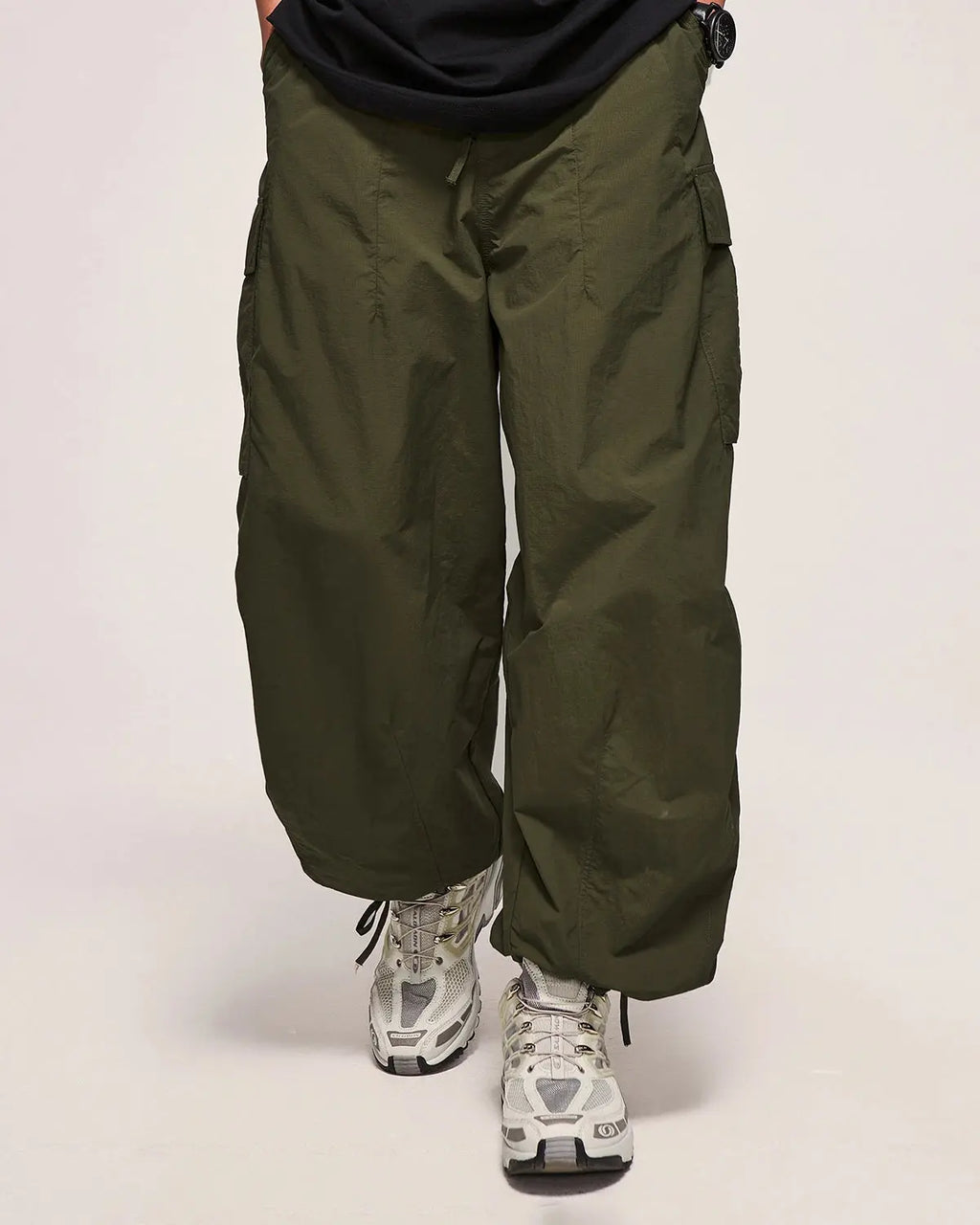 Inflation Streetwear classical parachute cargo pants with multiple pockets and relaxed fit, black fabric, streetwear style.