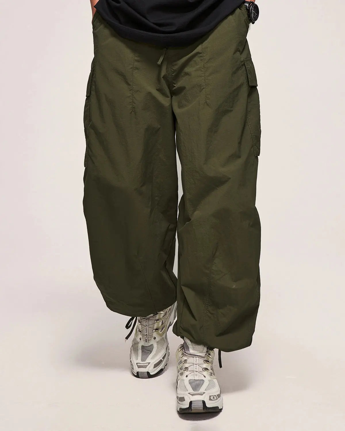 Inflation Streetwear classical parachute cargo pants with multiple pockets and relaxed fit, black fabric, streetwear style.