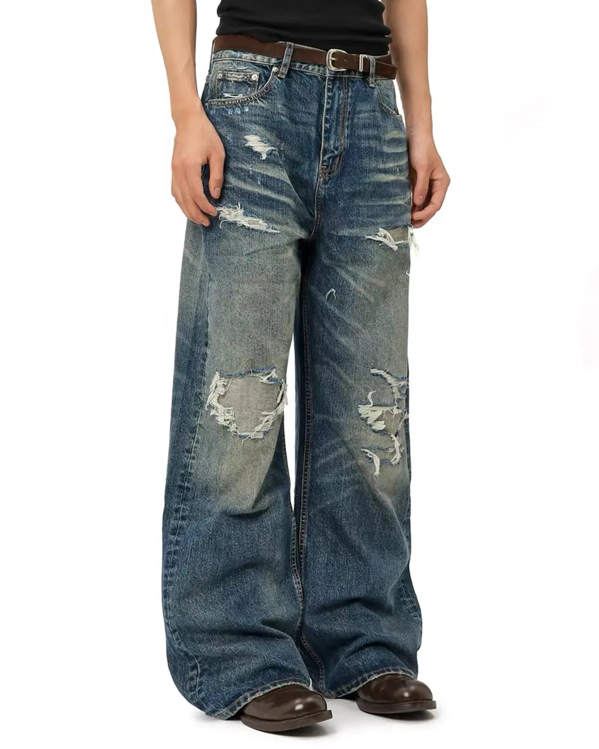 Vintage distressed baggy jeans by INFLATION with a relaxed fit, featuring faded and torn denim details on a casual streetwear style.