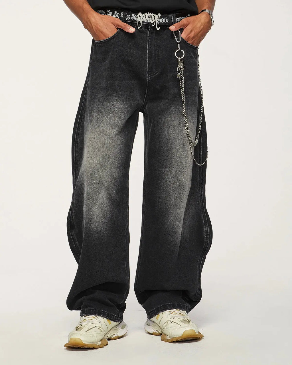 Inflation Wave Washed Baggy Jeans, relaxed-fit denim pants with a washed finish, shown on a model standing outdoors.