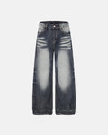 Faded Whisker Baggy Jeans by INFLATION featuring distressed denim and relaxed fit, displayed on a hanger against a neutral background.