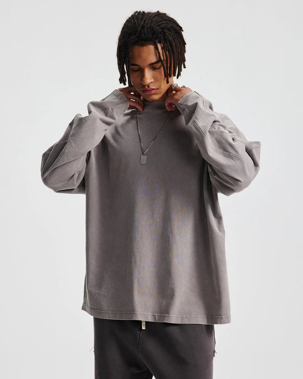 Distressed acid wash oversized long sleeve T-shirt by INFLATION, featuring a relaxed fit and vintage-inspired design.