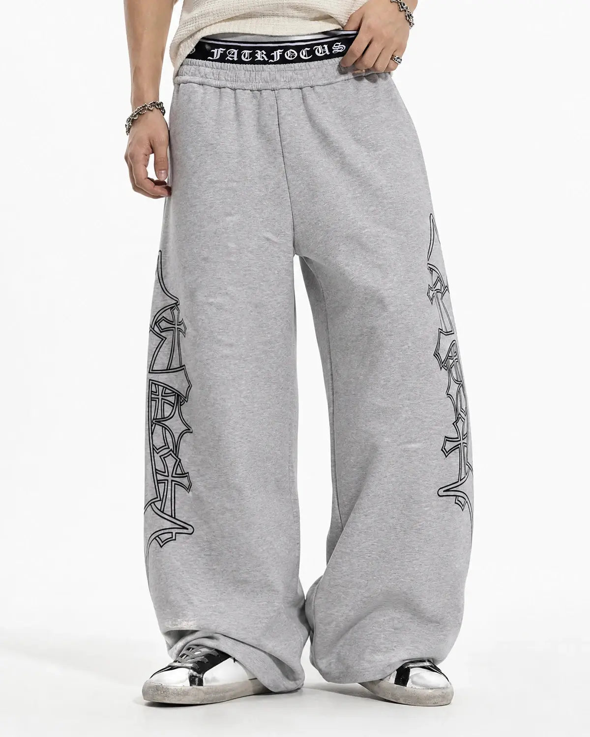Black gothic layered baggy sweatpants by INFLATION featuring a loose fit, layered design, and streetwear style.