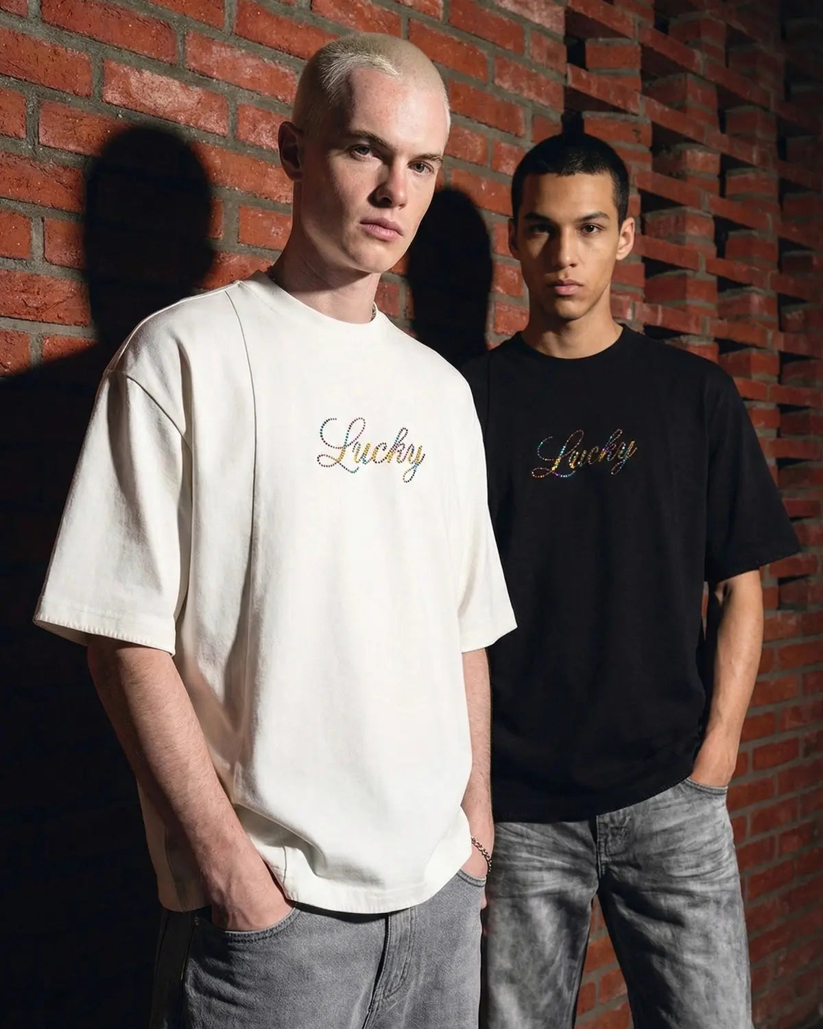 Inflation Streetwear oversized tee featuring rhinestone "Lucky" graphic design on white cotton fabric.