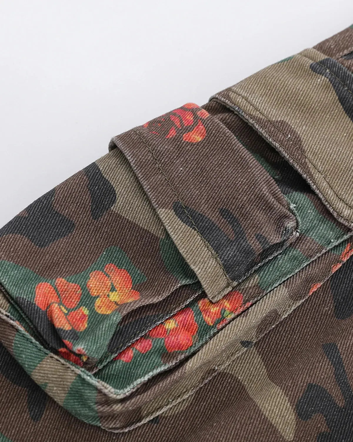 Inflation Floral Camo Cargo Longline Shorts displayed on a model, featuring a mix of floral and camouflage patterns with functional pockets.