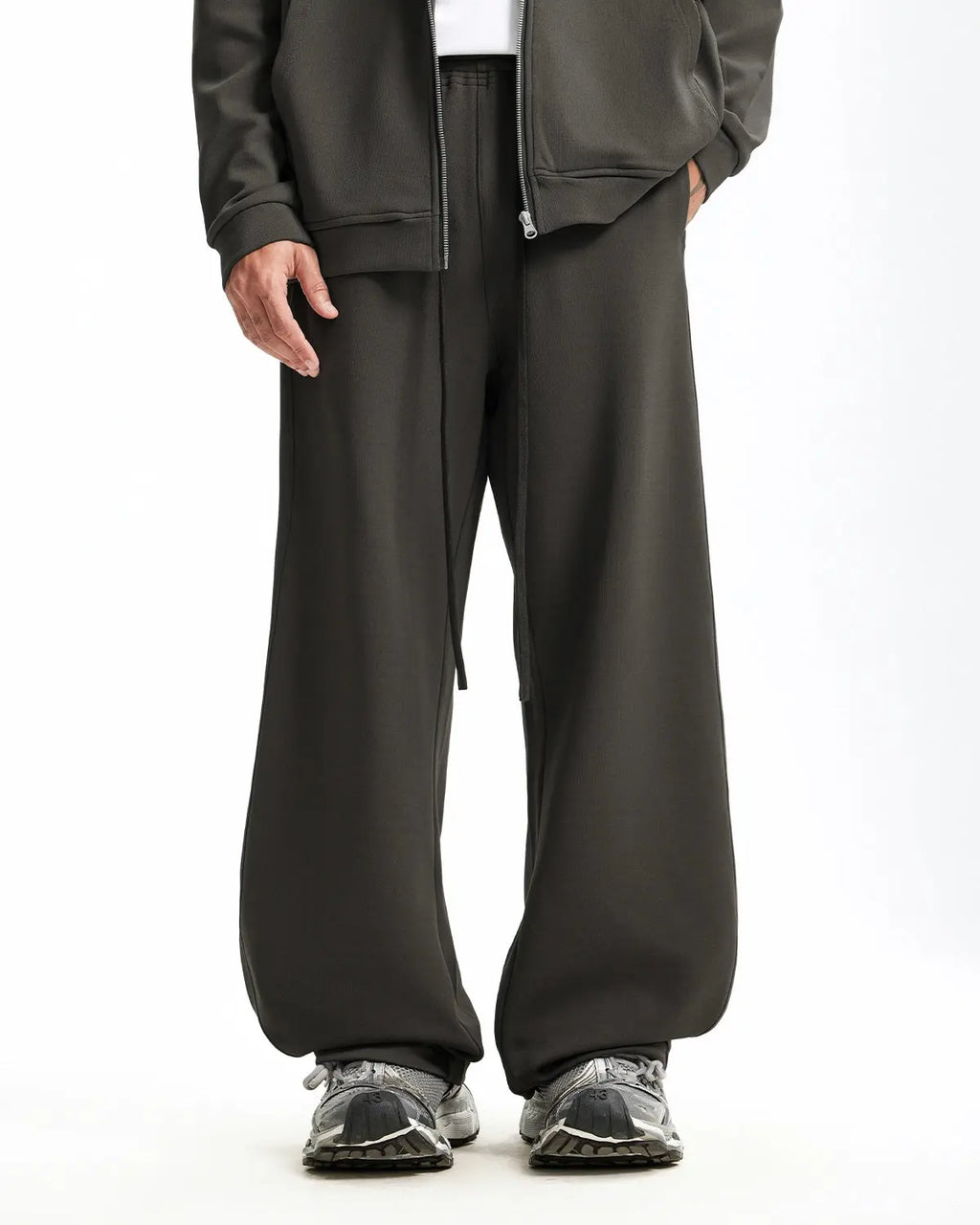 Grey baggy sweatpants by INFLATION with relaxed fit and comfortable fabric, shown laid flat on a white background.